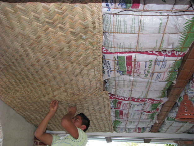 Installing mats over earthbag insulation