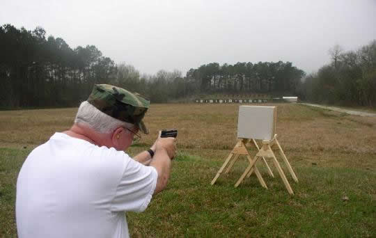 Testing bullet resistance of sandbags using boxes of sand.