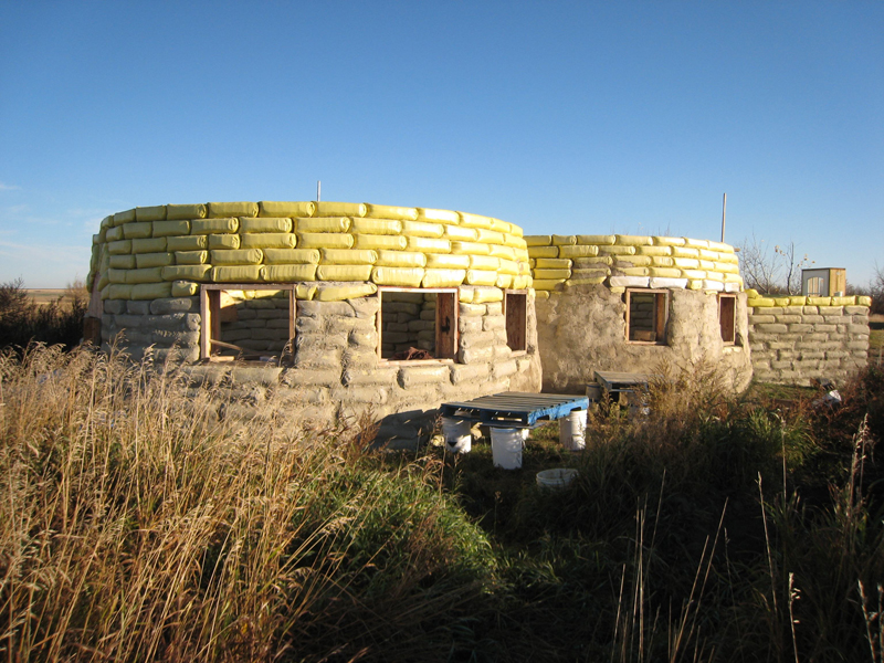 Image credit: Canadian Dirtbag Blog. A couple is building their off-grid earthbag home in Alberta, Canada.