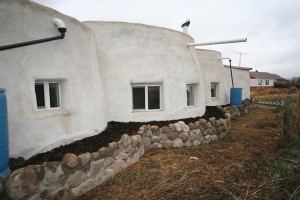 Exterior view of Canadian Dirtbags home with rock wall