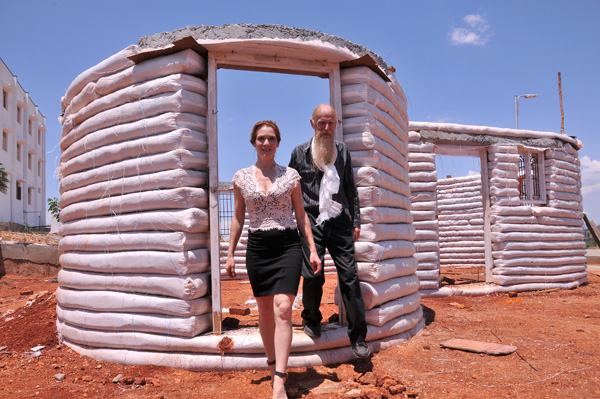Owen Geiger and Kateryna Zemskova step out from an earthbag meeting room under construction at Anna University, Madurai campus.