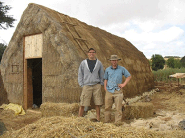 David Fortin, left, and Michael Spencer stand by the potato storage facility that they designed and helped build of straw-bale construction in Kenya.