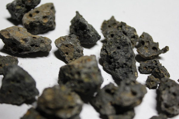 Vesicular basalt has lower R-value than scoria or pumice but is still suitable for earthbag building