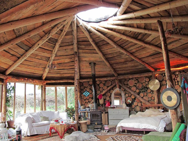 Beautiful interior of cordwood roundhouse by Plan-it Earth