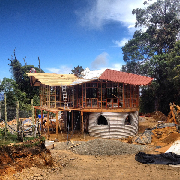Our house mid-construction. Earthbags on bottom, bamboo frames for wattle-and-daub on top.