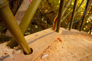 Earthen yurt made with bamboo and clay. The bamboo framework anchors into the deck.