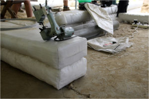 Sew gusseted earthbag ends with this small handheld electric sewing machine.