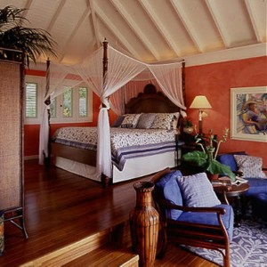Island style home interior with high ceilings and four-poster bed in the master suite.