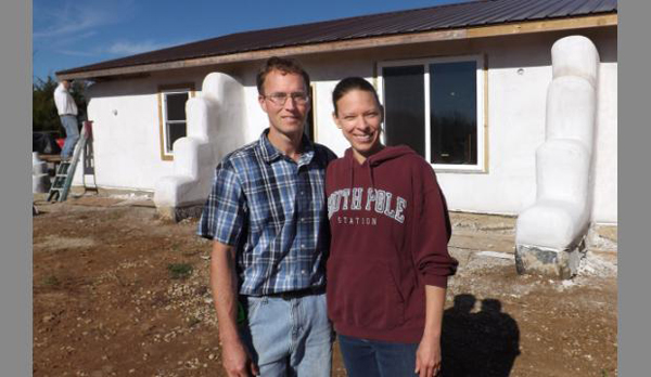 Keith and Lily Fouts stand in front of the earthbag house they are building for Keith's parents in eastern Kansas.