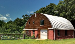 Strawbale barn in Minnesota with vaulted metal roof.