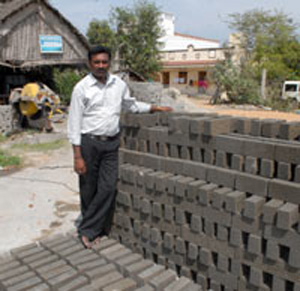 Gopalakrishnan with his eco-friendly rice husk ash bricks