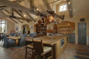 Custom kitchen with recycled wood timber trusses