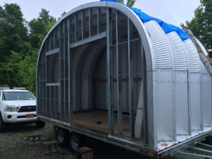Quonset style steel tiny house on wheels