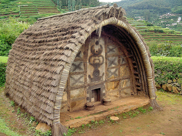 The hut of a Toda Tribe of Nilgiris, India. Note the decoration of the front wall, and the very small door.