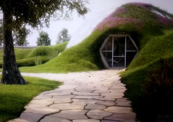 Underground dome home with living roof and greenhouse