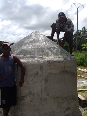 Earthbag tube water tank with domed ferrocement top